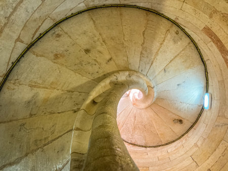 A closeup of spiral staircase with sunlightの写真素材