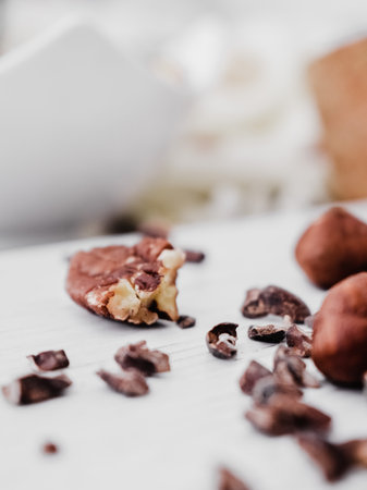 A vertical closeup shot of nuts and chocolate chips on a kitchen tableの写真素材
