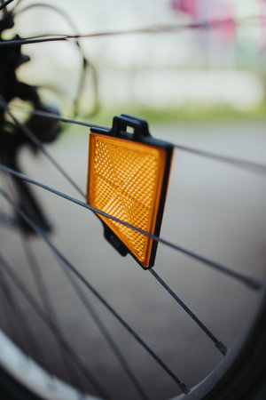 A closeup shot of a spoke reflector on the wheel of a bicycle
