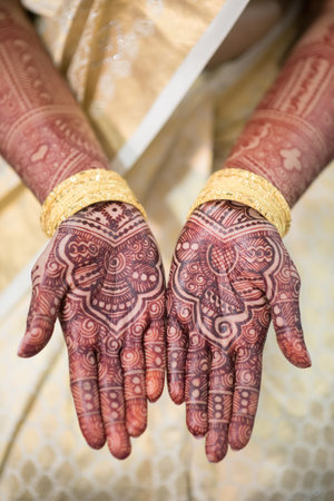 Bride's hands showing henna (mehndi) tattoos at Hindu weddingの写真素材