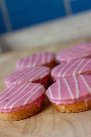 A vertical shot of pastries with pink creamの写真素材