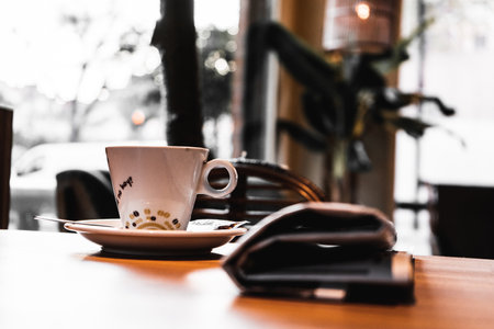 A selective focus shot of a cup of fresh morning coffee on a tableの写真素材