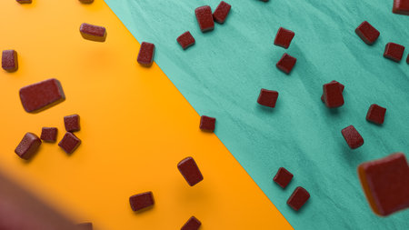 A 3D rendering of chocolate pieces on a yellow and blue backgroundの写真素材