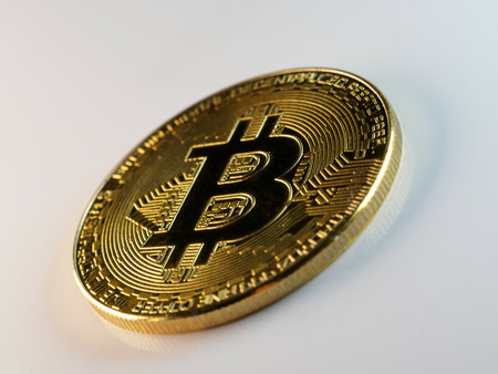 A closeup shot of golden bitcoin isolated on white backgroundの写真素材