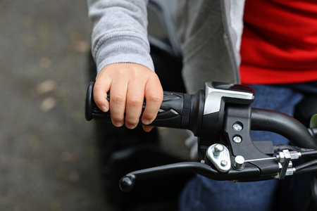 A shallow focus of a child's hand on the throttle of a quadの写真素材