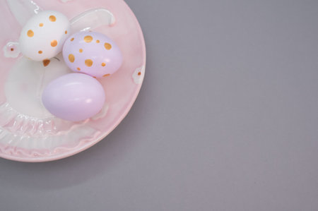 Decorated eggs in a plate isolated on purple backgroundの写真素材