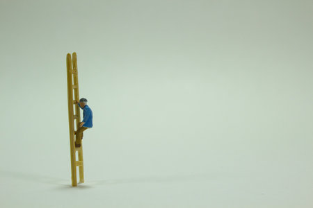 A closeup shot of a small figure of a worker on the staircaseの写真素材