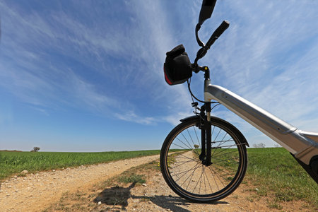An e-bike on the sandy road against the blue sky in springの写真素材