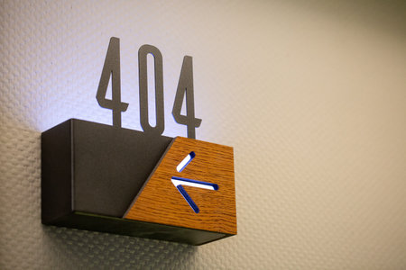 A closeup of 404 hotel room number with an arrow sign showing the directionの写真素材