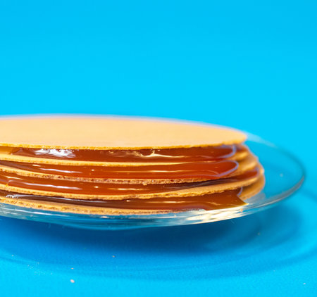 wafers with goat's milk candy on blue background. obleas, a typical sweet of mexico and latin...