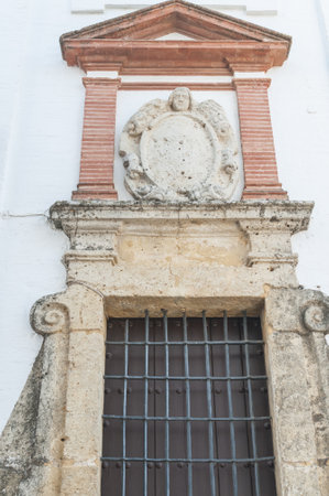 A closeup shot of an old vintage window stone-carved frame in Carmona, Sevilla province, Spainの写真素材