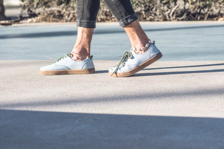 Male legs with sneakers outdoors
