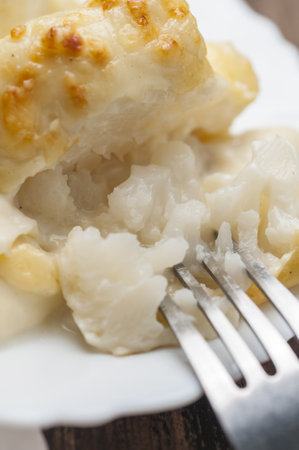 A vertical, close-up shot of baked cauliflower with bechamel gratinの写真素材