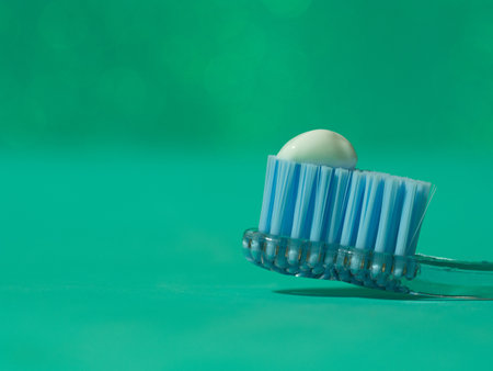 A macro shot of blue toothbrush bristles on green background with copy spaceの写真素材