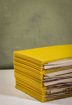 A closeup of pure beeswax comb sheet panels isolated on white surface