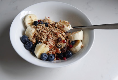 A delicious bowl of oatmeal with berries and bananas in itの写真素材