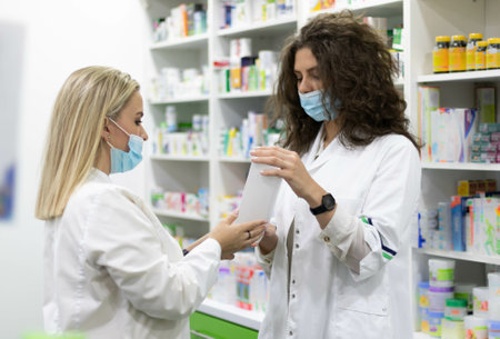 A shallow focus of pharmacists in a pharmacyの写真素材