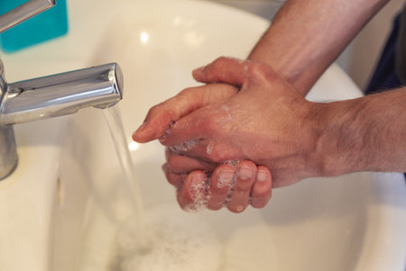 A closeup shot of a person washing his hands with a soapの写真素材