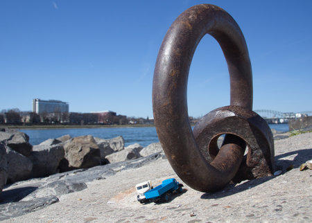 A closeup of the weathered rusty old iron mooring ring on the coast