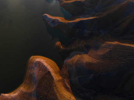 Panoramic view of hills and a lake in the sunset time. Top view, background, wallpaper during the golden hour.の写真素材