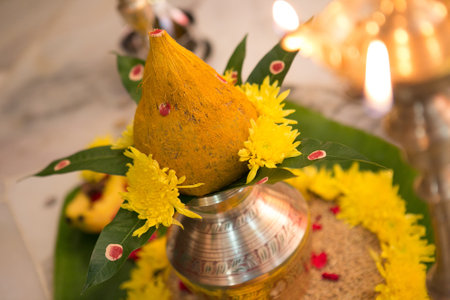 The decorative metal kalasha (metal pot) with green leaves and coconut - Indian wedding ceremonyの写真素材