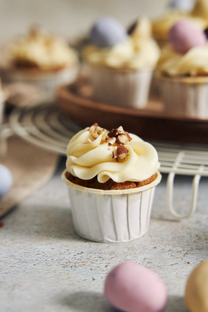 A delicious carrot cupcake with whipped cream and topping from nutsの写真素材