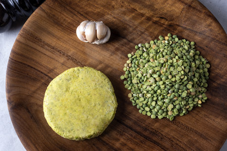 A closeup shot of raw healthy cutlet with ingredients on a wooden board