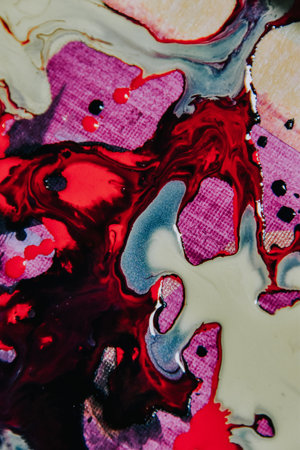 A vertical shot of an abstract painting with mixed red and white oil paint colors