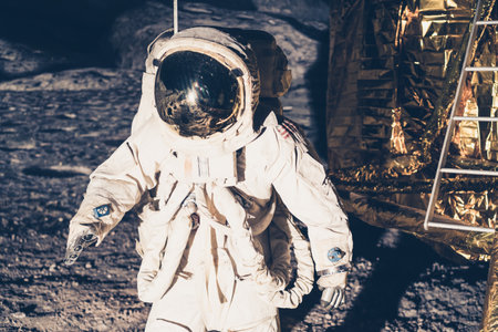 A closeup of an astronaut wearing a white astronaut costume walking on the moonの写真素材