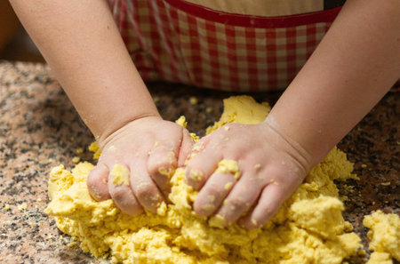 A close-up shot of a baker kneading a lump of dough
