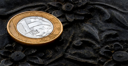 A closeup shot of a Brazilian real coin on a black surfaceの写真素材