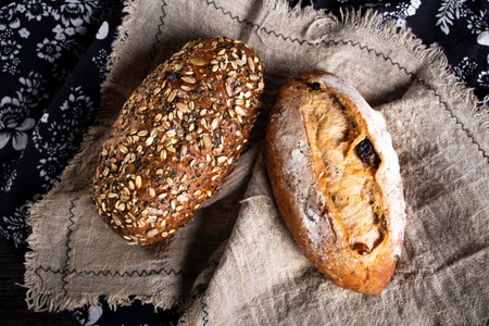 A top view of  breads with nuts on a brown clothの写真素材