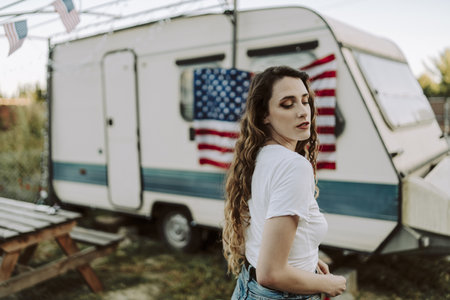 A beautiful Spanish female posing on background of the US flag - US Independence dayの写真素材