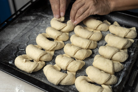 A closeup shot of a person making croissants in the kitchenの写真素材