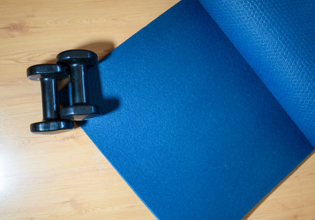 A high angle shot of dumbbells and home training matの写真素材