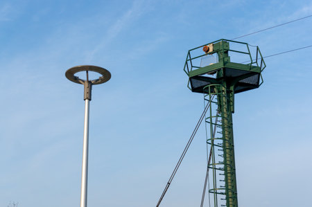 High lamp post and a watch towerの写真素材
