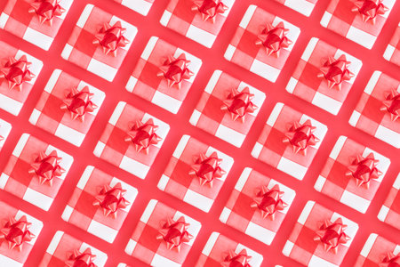 An overhead shot of a small gift wrapping paper pattern with red background.の写真素材