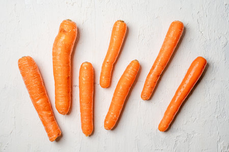 A closeup shot of fresh carrots isolated on a white surfaceの写真素材