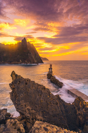 A vertical shot of the sunset at the lighthouse in the Pasajes San Juan municipality, Gipuzkoa,...
