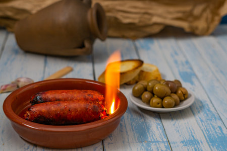 spicy chorizo to hell cooked over a fire right on the tableの写真素材