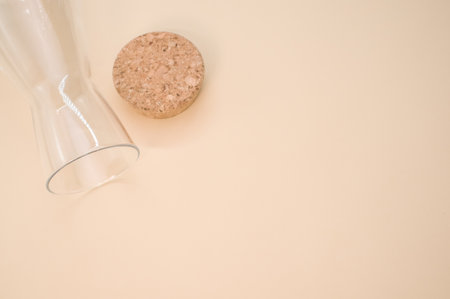A closeup shot of an empty glass with a cork cover isolated on a pink background with copyscapeの写真素材