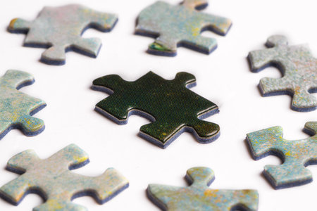 Black puzzle piece surrounded by white pieces. Oppression concept.
