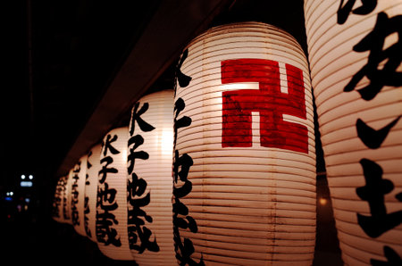 A closeup shot of  beautiful lanterns with signs on the night streetの写真素材