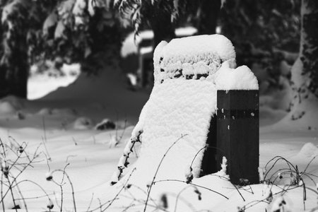 A selective focus shot of a snow-covered gravestone