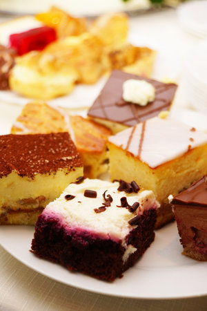Variation of cakes served on platesの写真素材