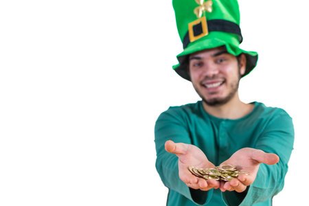 A lovely man in a leprechaun hat wearing a green costume for a party offering gold coins on St.Patrick's dayの写真素材