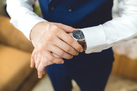 A closeup shot of a businessman checking his watchの写真素材