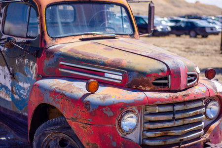 The closeup of the old red truck in a junkyardの写真素材