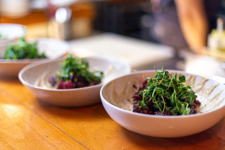 A selective focus shot of a delicious salad with greens and vegetables in the plates