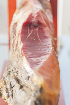 A vertical shot of raw serrano ham from Iberian pigsの写真素材